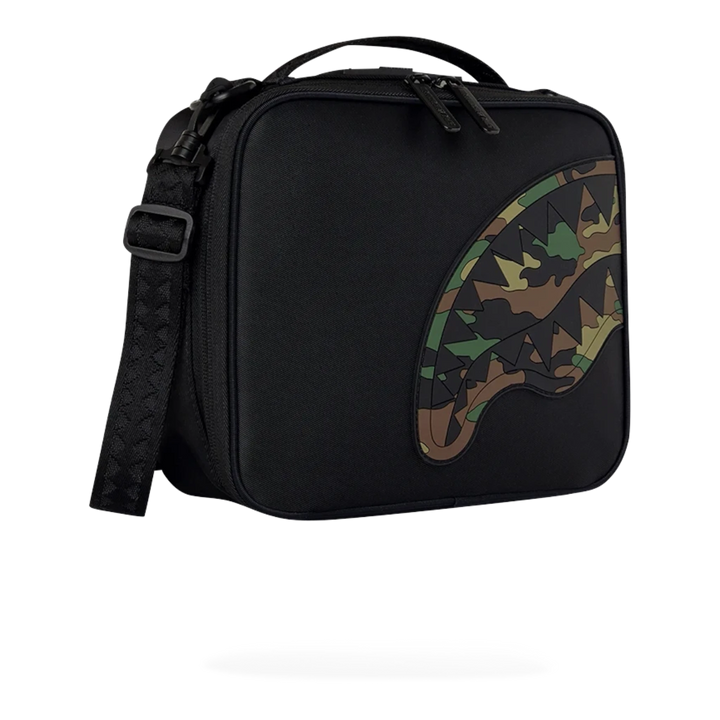 HypeSelection Sprayground black nylon snackpack with embossed camo shark mouth graphic and adjustable shoulder strap.