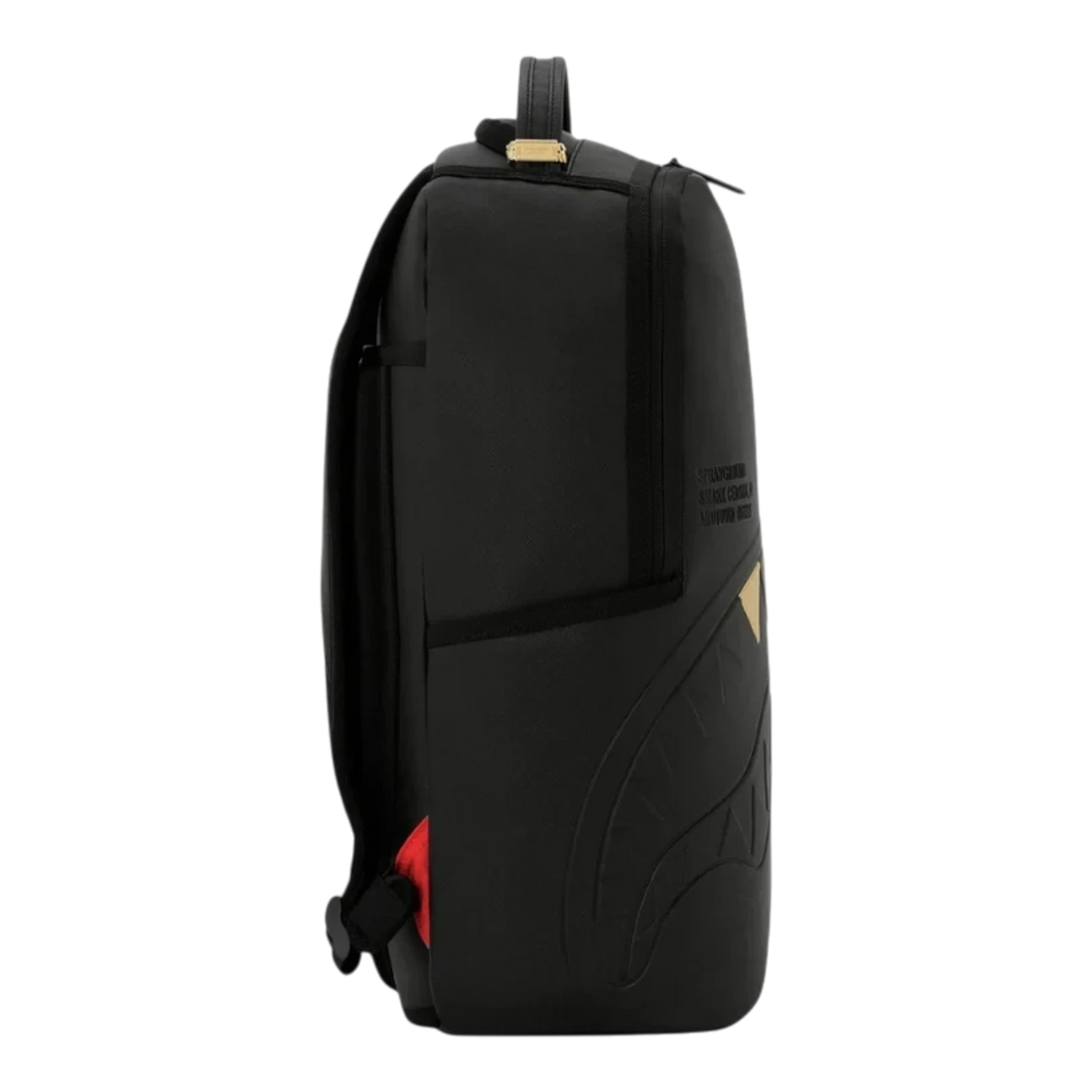 HypeSelection black Sprayground backpack with embossed gold tooth graphic and side view profile