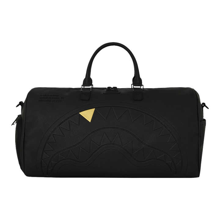 HypeSelection Sprayground black duffle bag featuring an embossed sharkmouth design with a metallic gold tooth detail.