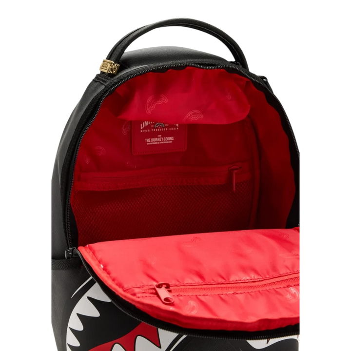 HypeSelection Sprayground Black Toon Shark Mini DLX backpack with open red interior lining and mesh pocket
