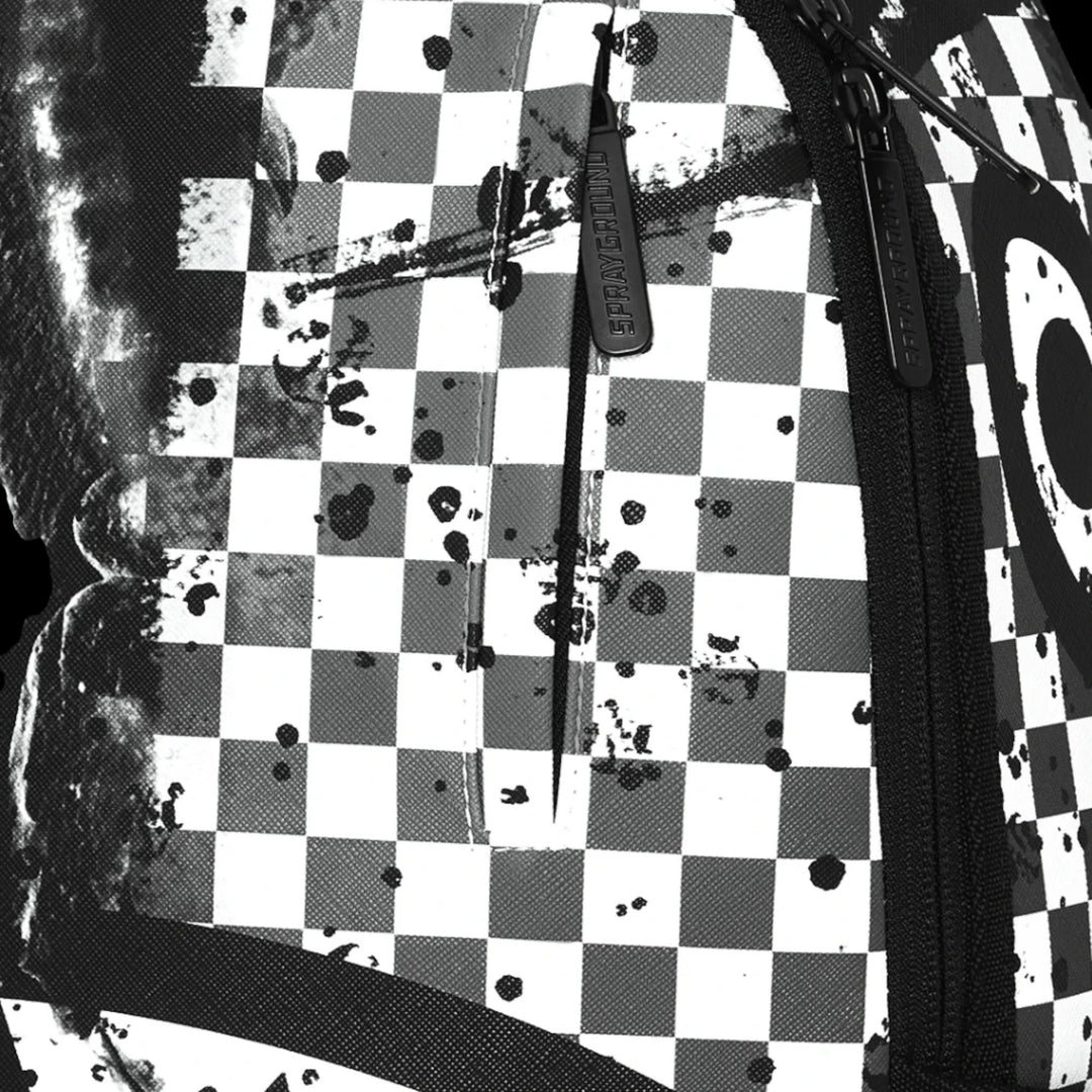 HypeSelection Sprayground backpack featuring a black and white checkered pattern with artistic paint splatter details.