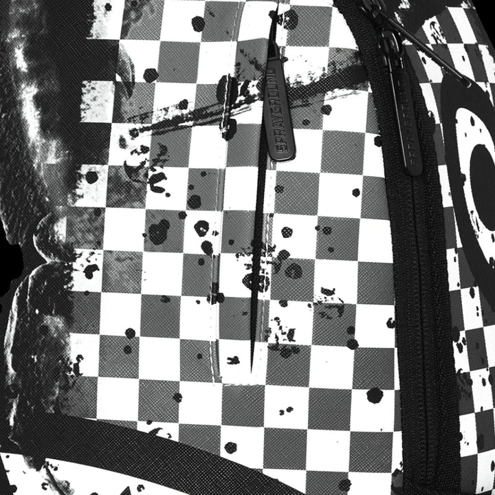 HypeSelection Sprayground backpack featuring a black and white checkered pattern with artistic paint splatter details.