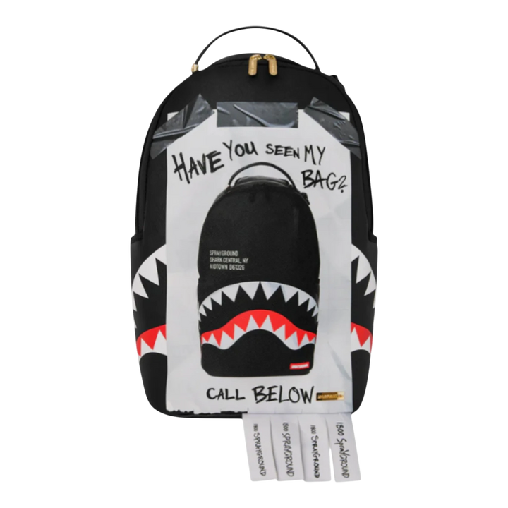 HypeSelection Sprayground Missing Bag Flyer backpack with shark teeth graphic and tear-off phone number tabs. Black faux leather.