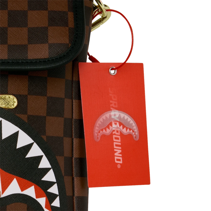 HypeSelection Sprayground Gold Drip messenger sling bag featuring brown checkerboard pattern and iconic shark mouth