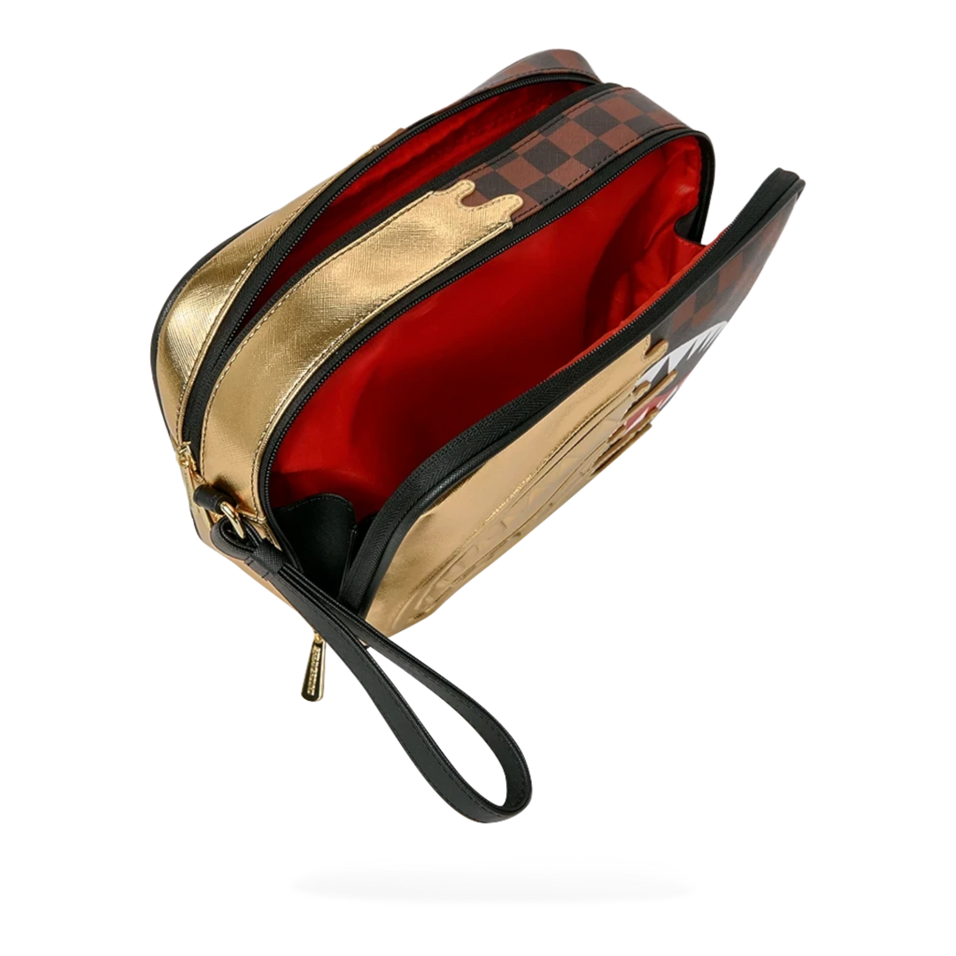 HypeSelection Sprayground Sharks In Paris gold toiletry bag with signature graphic print and red interior lining.
