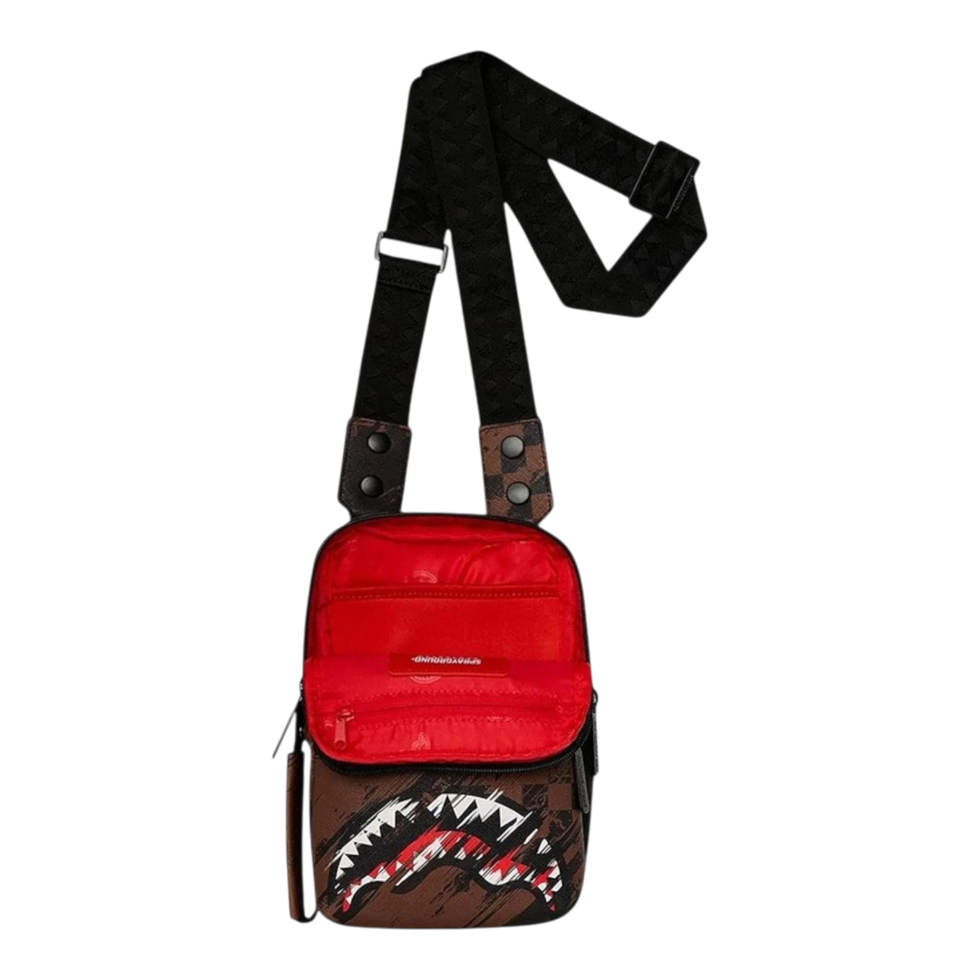 HypeSelection Sprayground Smeared Grunge OG sling bag in brown with red interior and iconic shark mouth graphic.