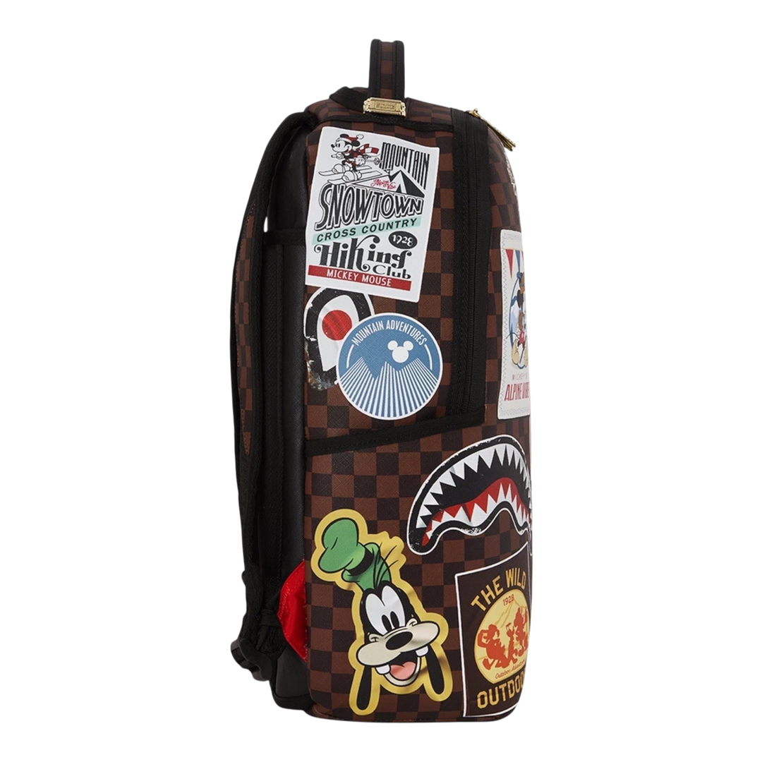 HypeSelection Sprayground Mickey Global Mogul backpack with brown checkered pattern and colorful character patches.