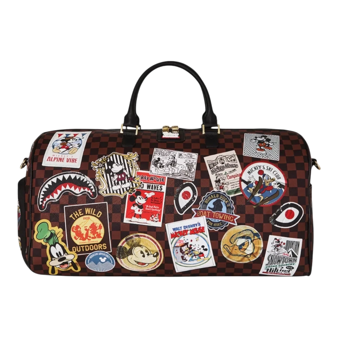 HypeSelection Sprayground Mickey Global Mogul duffle bag with brown checkered pattern and colorful Disney patches