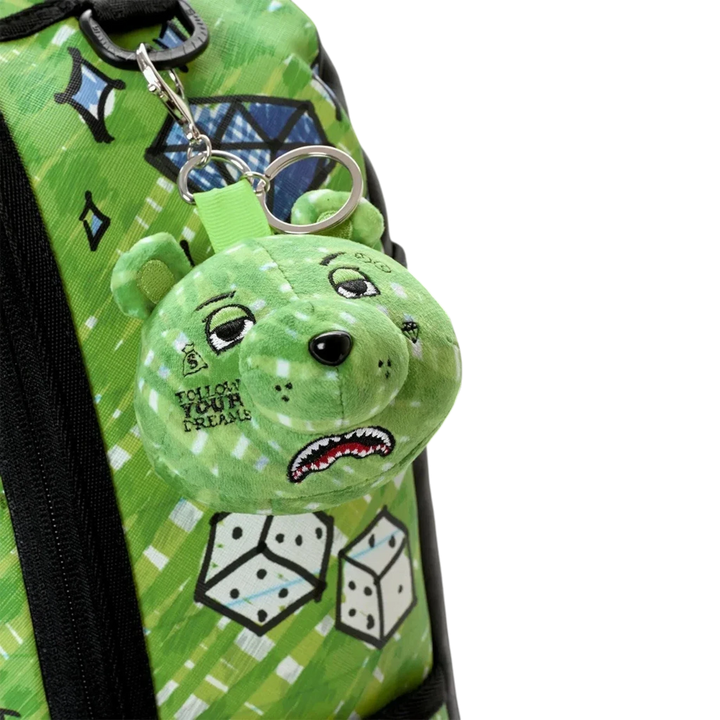 HypeSelection Sprayground Money Bear Doodle backpack featuring a green plush bear keychain with graphic print details.