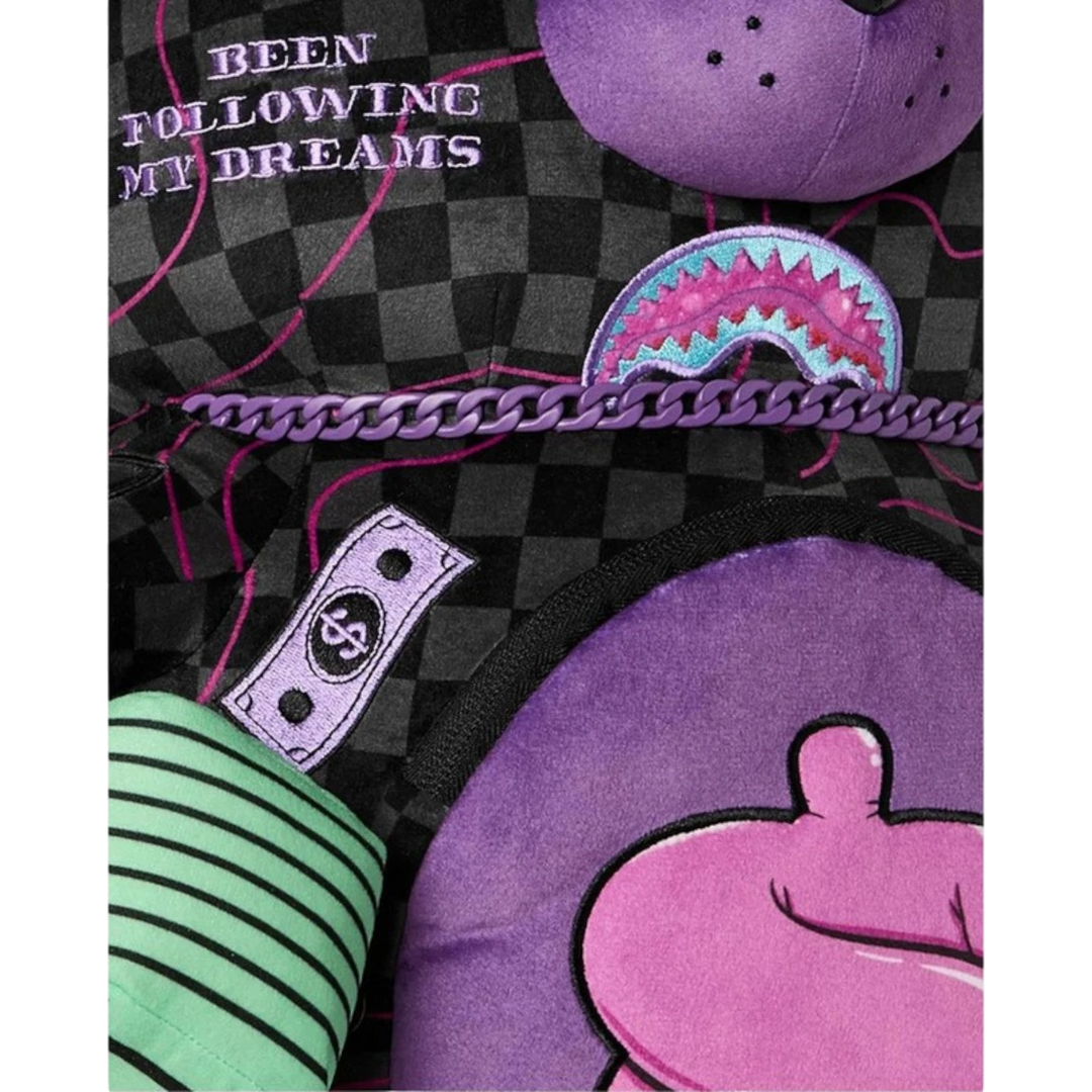 HypeSelection Sprayground Moneybear backpack featuring purple slime, black checkerboard pattern, and dollar sign detail.
