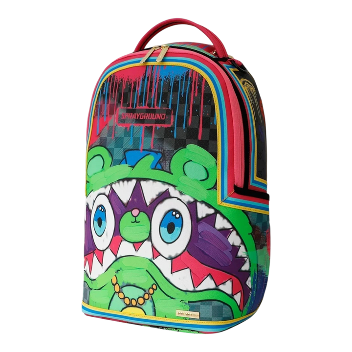 HypeSelection Sprayground New Gary DLXSV backpack featuring a vibrant graffiti-style character print and gold zippers.
