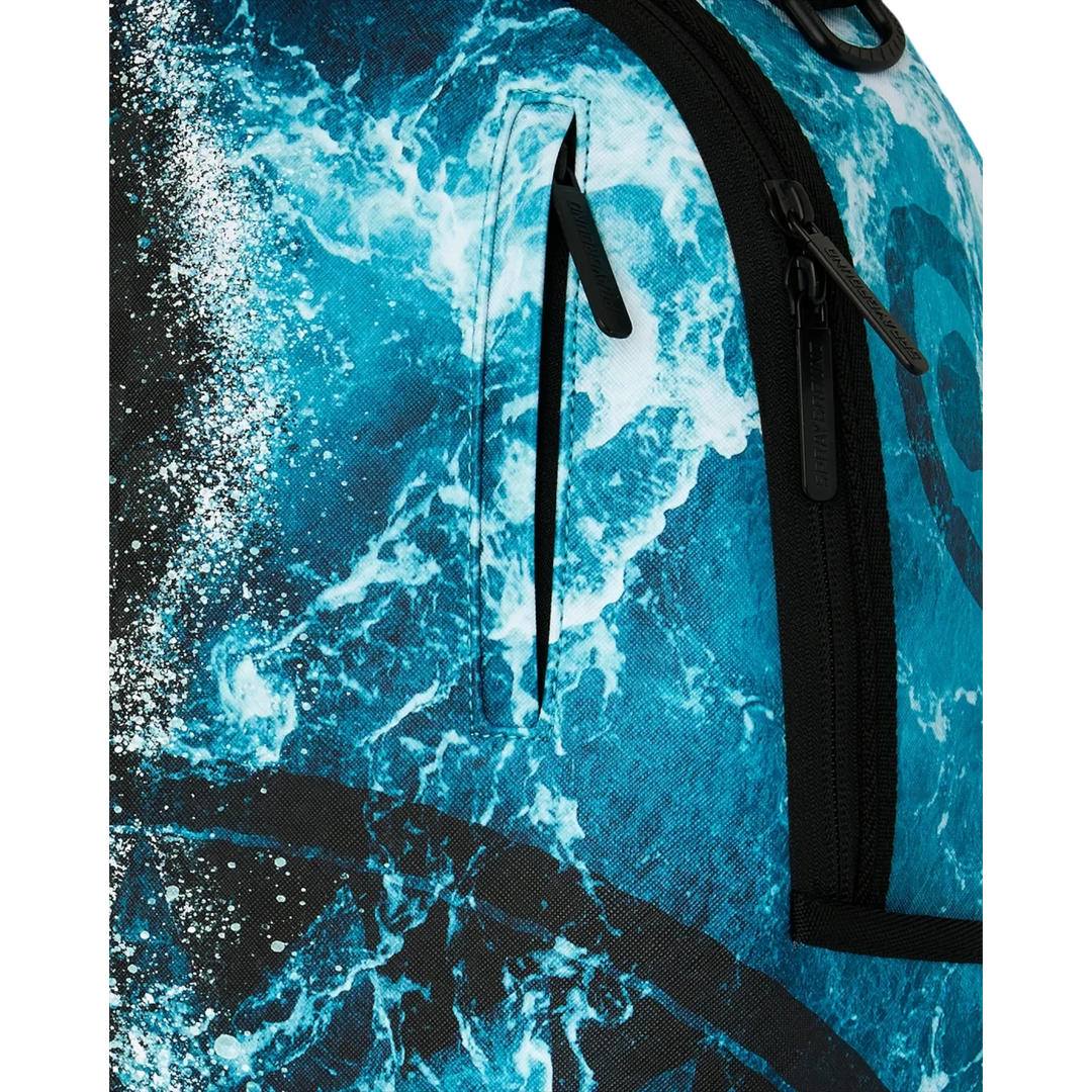 HypeSelection Sprayground Split Ocean Deep backpack featuring a vibrant blue ocean wave graphic and black zipper detail