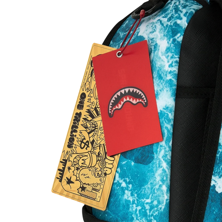 HypeSelection Sprayground Split Ocean Deep backpack featuring blue ocean wave print and iconic shark mouth hang tag