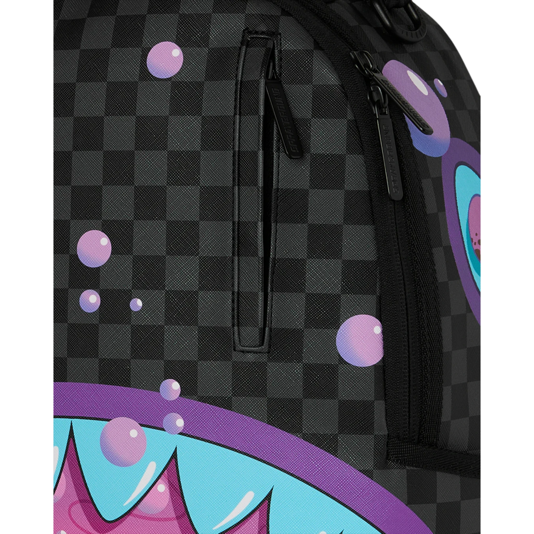 HypeSelection Sprayground purple slime takeover backpack with checkered pattern and shark mouth graphic.