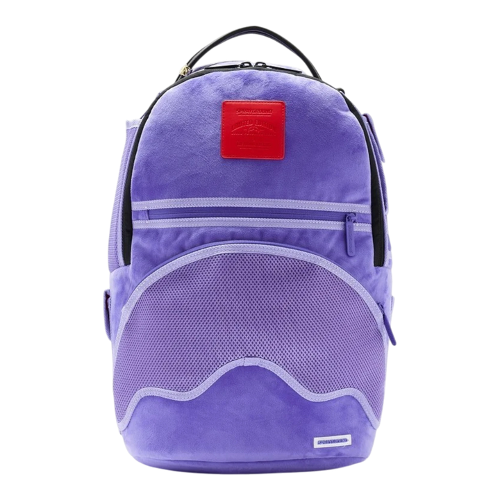 HypeSelection Sprayground purple velvet reversible backpack with a red logo patch and front mesh pocket