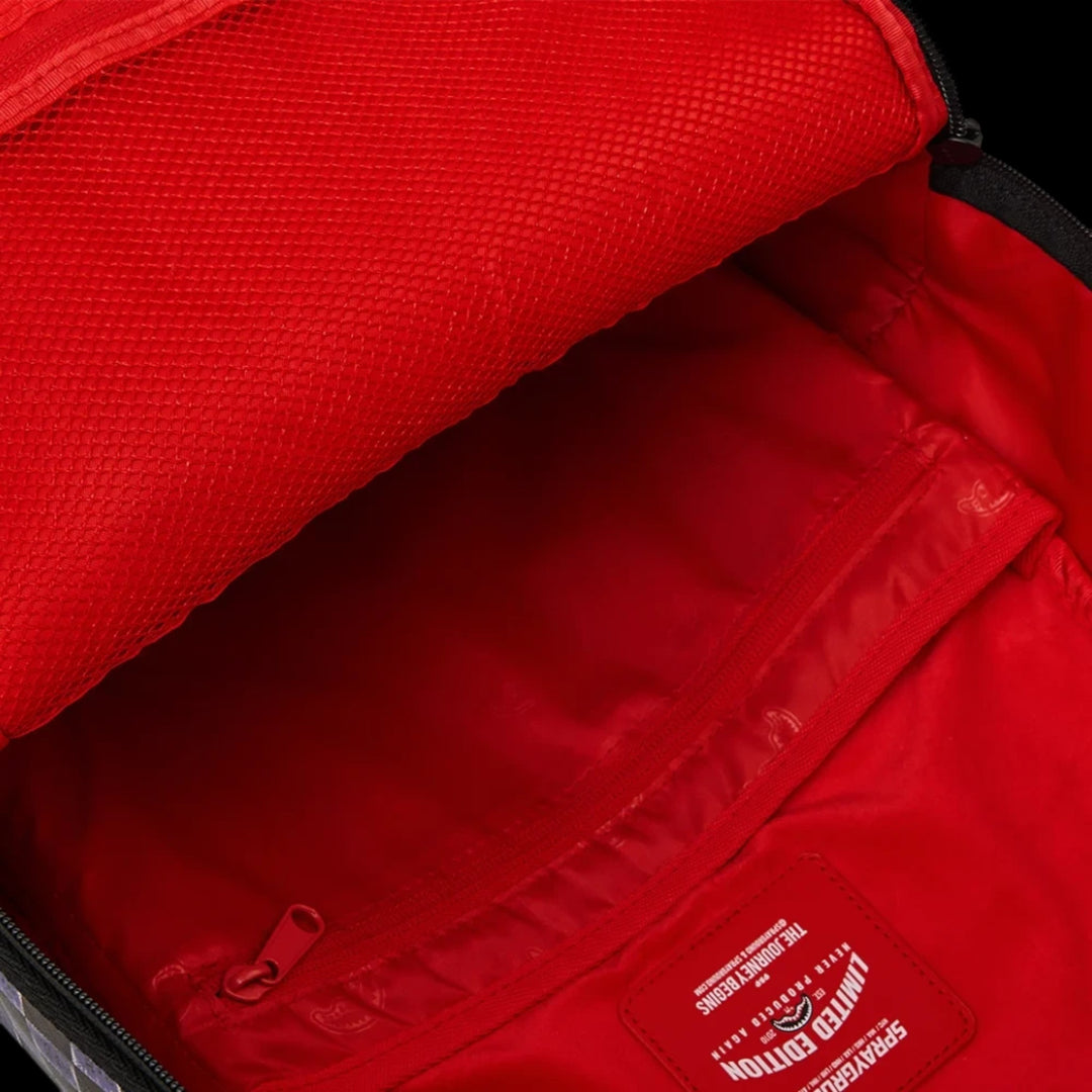 HypeSelection Sprayground Scratch Off Shark DLXSV backpack interior with red lining and mesh storage pocket