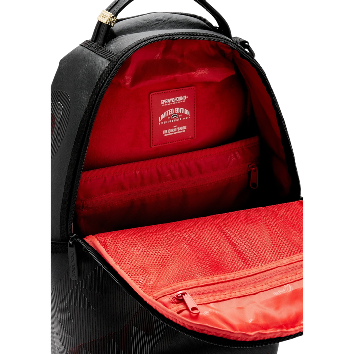 HypeSelection Sprayground Disappearing Shark DLXSV backpack with black exterior and vibrant red interior lining