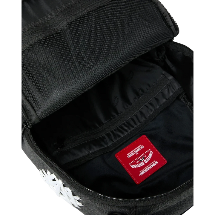HypeSelection Sprayground Shoelace Shark DLXSV backpack interior with black lining, mesh pocket, and red logo patch.