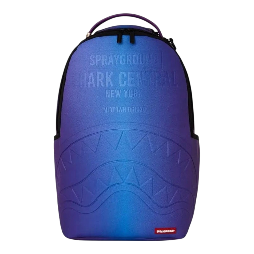 HypeSelection Sprayground Shark Central embossed nylon backpack in blue and purple gradient with sharkmouth detail