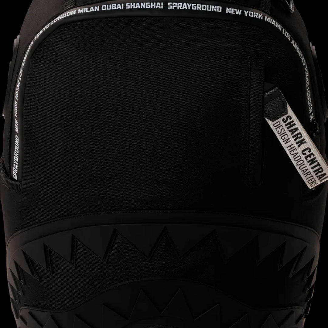 HypeSelection Sprayground Shark Central black backpack featuring signature shark mouth graphic and city name trim.