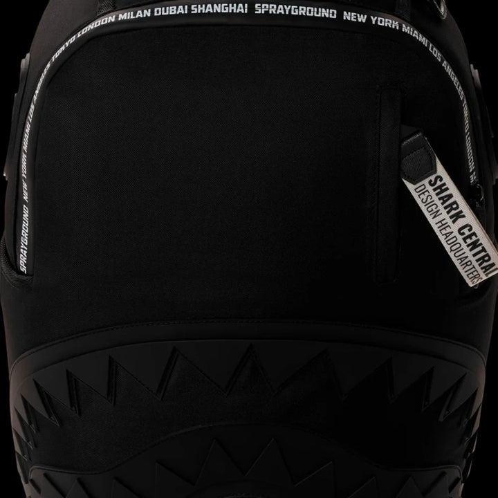 HypeSelection Sprayground Shark Central black backpack featuring signature shark mouth graphic and city name trim.