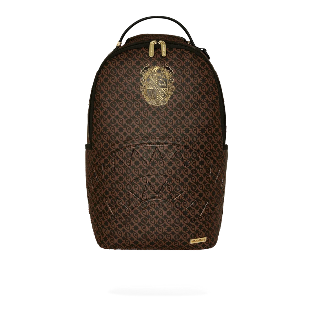 HypeSelection Sprayground Sharks South Of France brown PVC backpack with gold emblem and signature shark mouth design