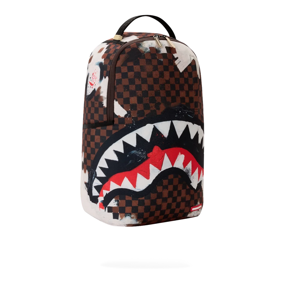 HypeSelection Sprayground Sharks In Paris backpack featuring a brown checkered pattern with a bold shark mouth graphic.