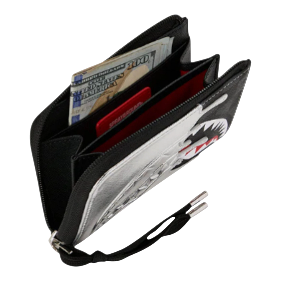 HypeSelection Sprayground metallic silver wallet with shark graphic and black trim, open to show cash and cards.