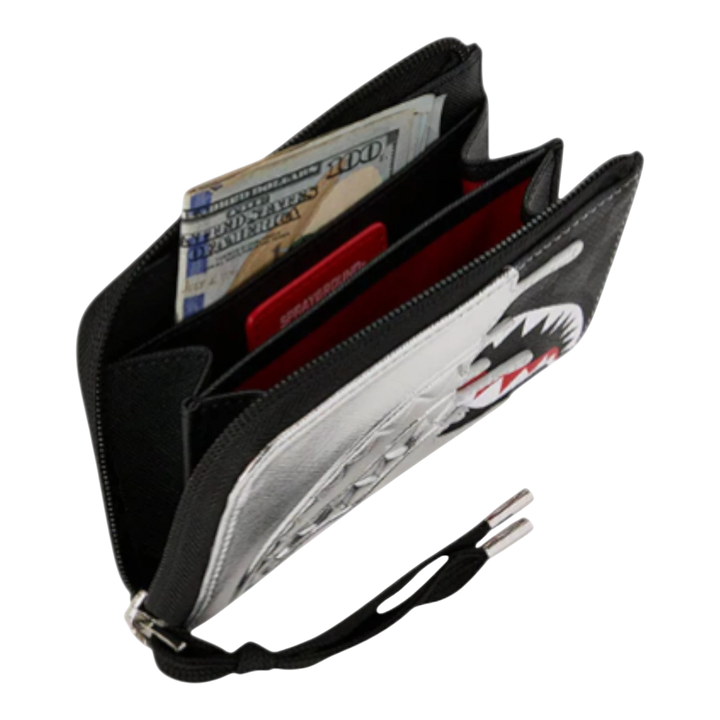 HypeSelection Sprayground metallic silver wallet with shark graphic and black trim, open to show cash and cards.