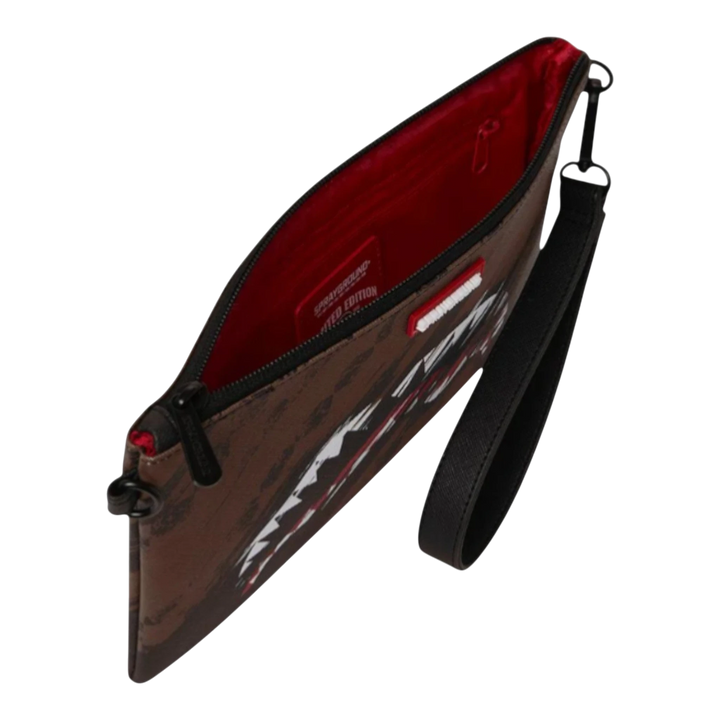 HypeSelection Sprayground Smeared Grunge brown clutch with red interior and black wristlet strap.