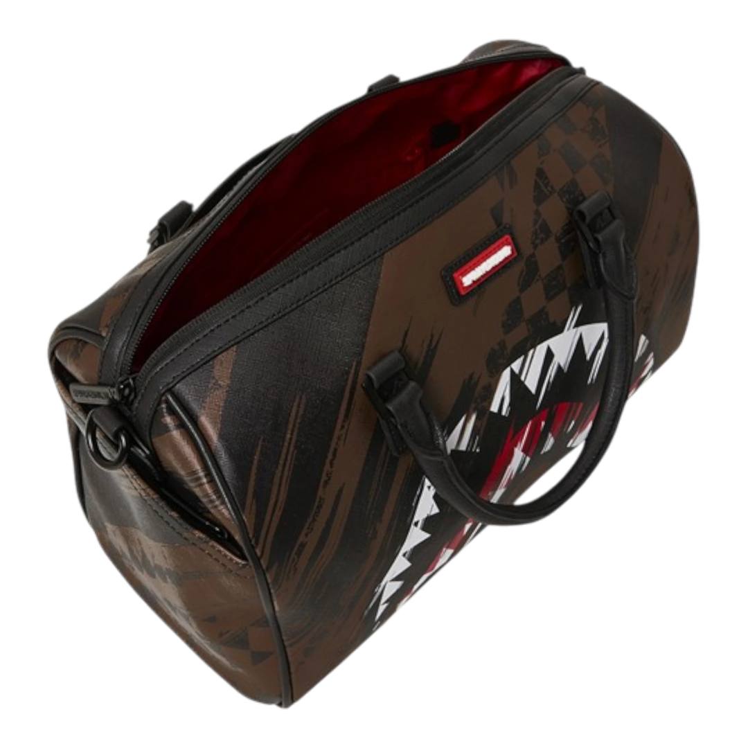 Sprayground Smeared Grunge Mini Duffle bag in brown with shark graphic and distressed paint-smear pattern. Made of PVC.