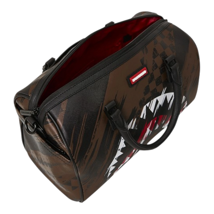 Sprayground Smeared Grunge Mini Duffle bag in brown with shark graphic and distressed paint-smear pattern. Made of PVC.