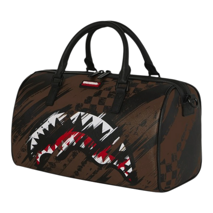 HypeSelection Sprayground Smeared Grunge mini duffle bag in brown with shark graphic and checkered pattern. Made of PVC.
