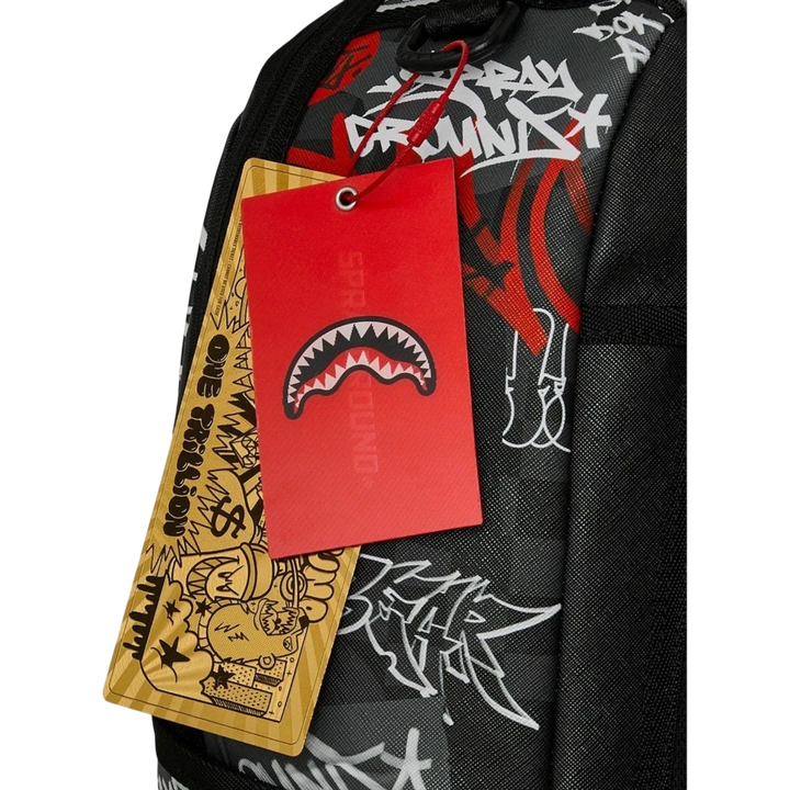 HypeSelection Sprayground Tagged Up DLXSV backpack featuring black fabric with white graffiti print and red shark tag