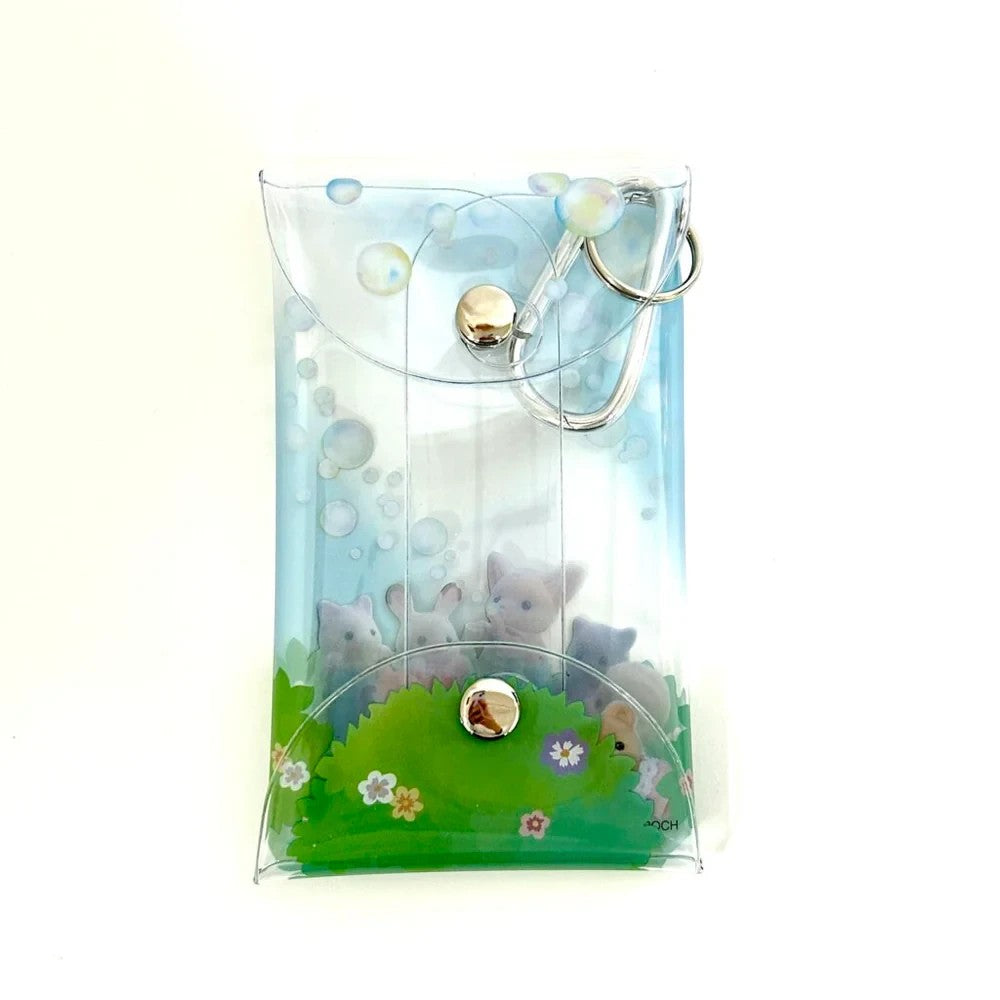 HypeSelection Sylvanian Families clear pouch with a soap bubble design and a snap closure. Features tiny animal figures.