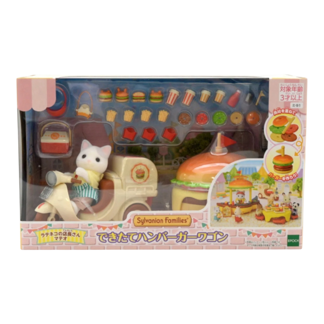 HypeSelection Sylvanian Families Freshly Made Hamburger Wagon playset with cat figure on scooter, transforming burger restaurant, and accessories.