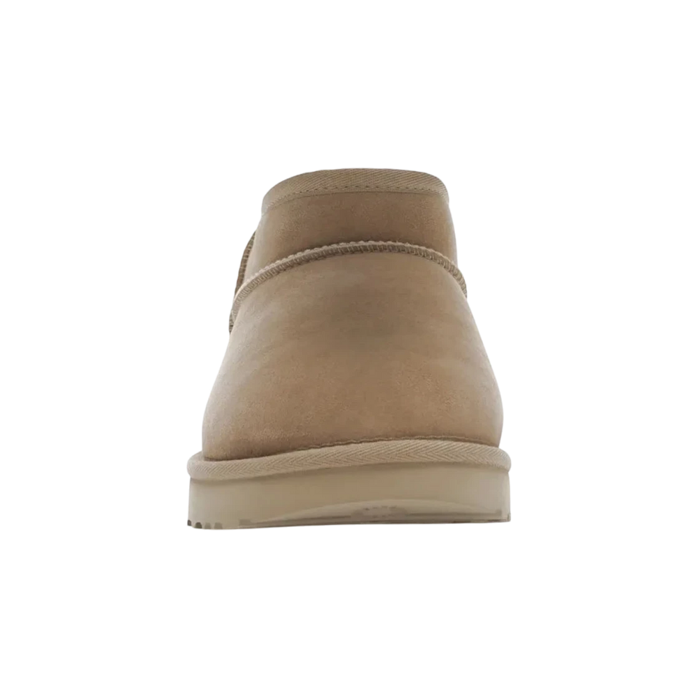 HypeSelection Sand UGG Classic Ultra Mini Boot, crafted from twinface sheepskin and suede with a UGGplush lining and SugarSole EVA outsole.