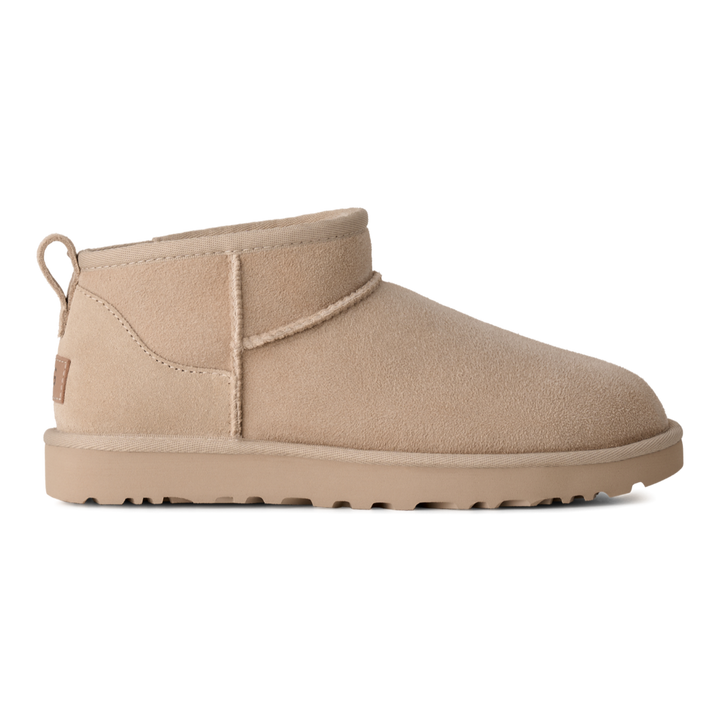 HypeSelection UGG Classic Ultra Mini boot in moonlight beige suede with an asymmetrical topline and pull tab.