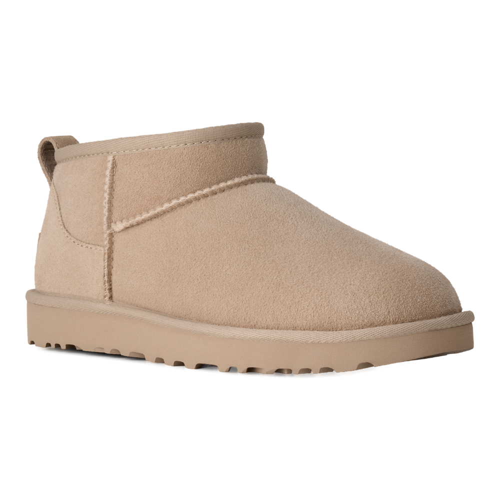 HypeSelection UGG Classic Ultra Mini boot in moonlight beige suede with an asymmetrical topline and pull tab.