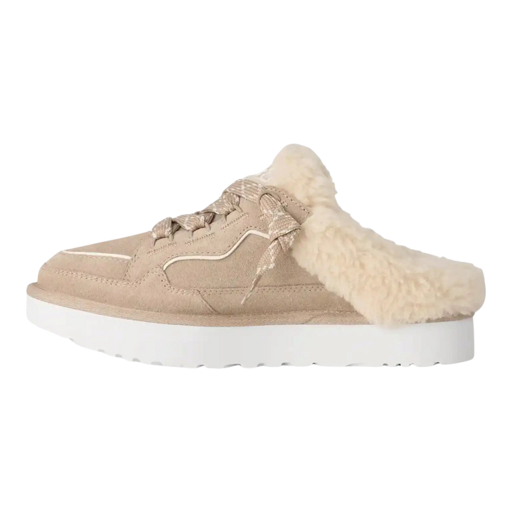 HypeSelection UGG Lowmel mule in Moonlight beige suede with curly wool lining, padded tongue, and white EVA outsole.