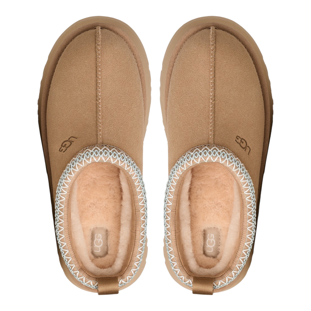 HypeSelection UGG Tazz II slippers in sand suede with sheepskin lining, platform EVA sole, and signature UGGbraid trim.