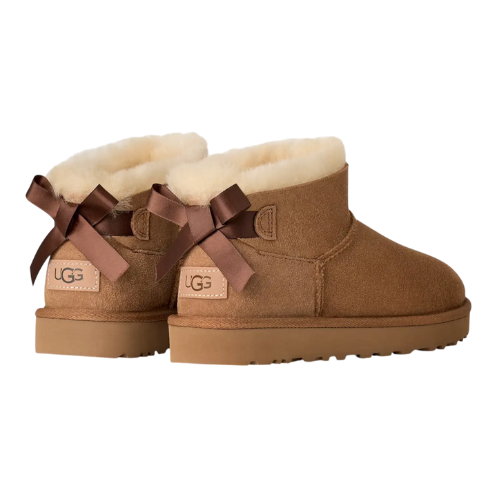 HypeSelection UGG Ultra Mini Bailey Bow boots in chestnut suede with back satin bows and plush wool lining.