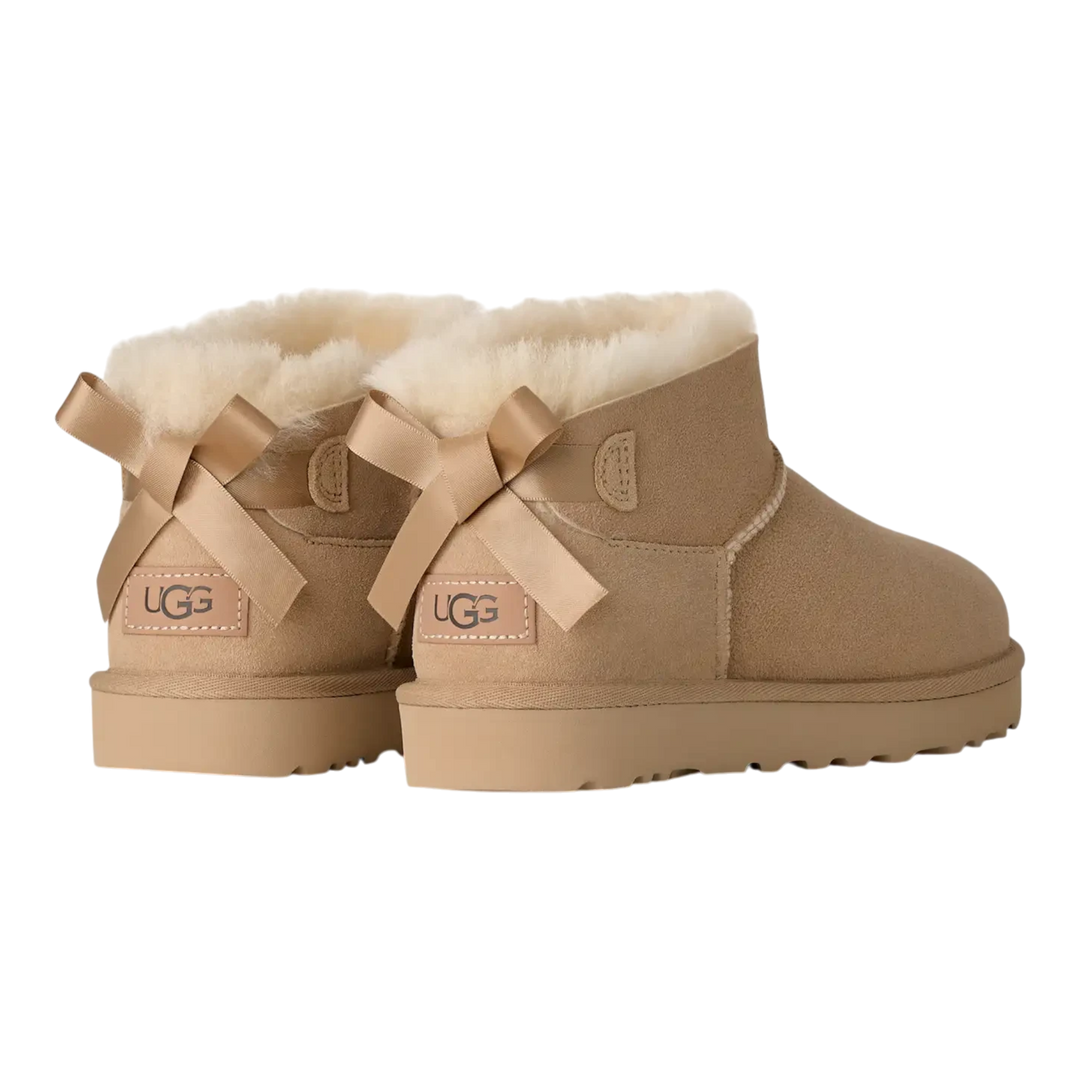 HypeSelection UGG Ultra Mini Bailey Bow boots in sand suede with back satin bows and plush wool lining