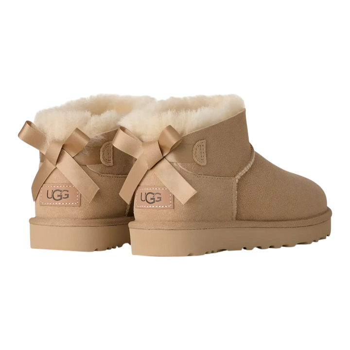 HypeSelection UGG Ultra Mini Bailey Bow boots in sand suede with back satin bows and plush wool lining