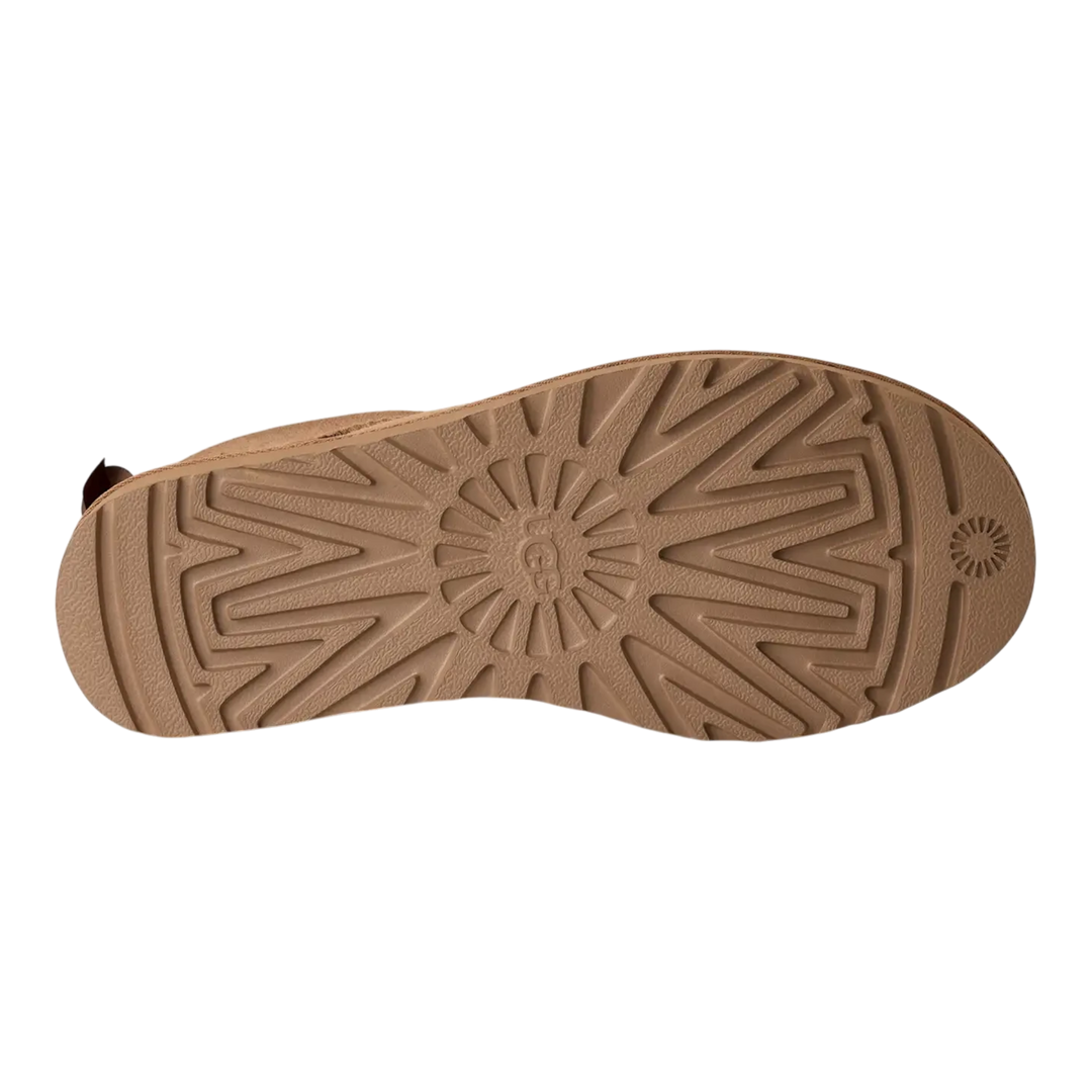HypeSelection UGG Ultra Mini Bailey Bow boot showing the textured brown rubber outsole with signature tread pattern.