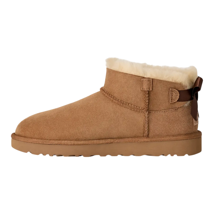 HypeSelection UGG Ultra Mini Bailey Bow boot in chestnut suede with a plush wool lining and back satin bow detail.