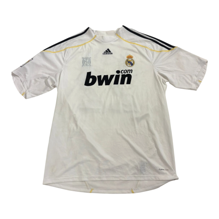 Vintage white Adidas Real Madrid jersey with black and gold trim, featuring the Bwin logo and Adidas branding.