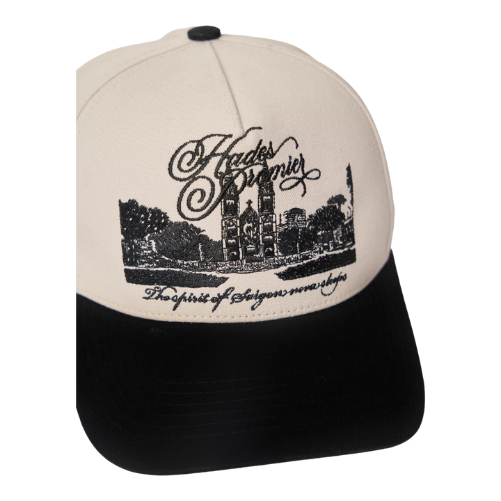 HypeSelection white cotton khaki cap with black brim, featuring embroidered Notre-Dame Cathedral Saigon and text.