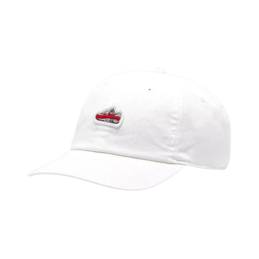 White cotton Nike Air Max 1 cap with embroidered red and white sneaker graphic on the front. Unstructured 6-panel design with pre-curved bill.